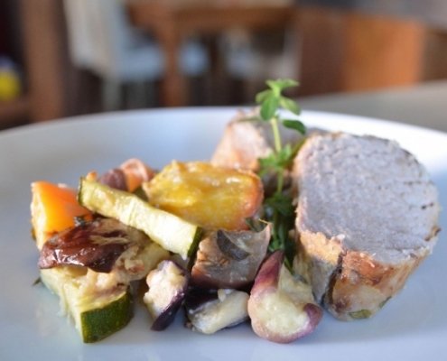 Easy Mustard Glazed Pork Loin with Summer Peach Ratatouille 8 Closeup of Pork Loin with Peach Ratatouille on a blue plate