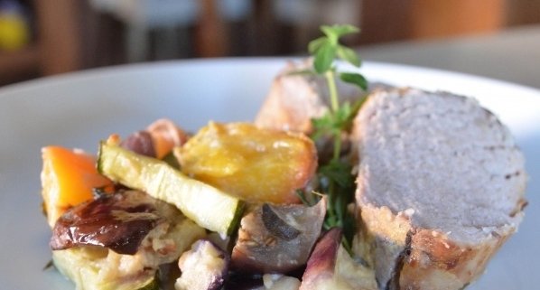 Closeup of Pork Loin with Peach Ratatouille on a blue plate