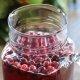 sparking Christmas punch in a large, glass jar with fresh cranberries floating on top