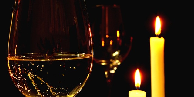 A glass of wine in candlelight to represent sexy dinner recipes