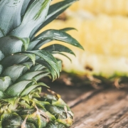 closeup of cut up pineapple on a wooden table