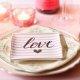 Table setting for Valentine's Day with a love napkin and pink candles