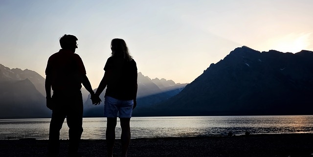 Romantic Travel 1 Romantic travel image of couple holding hands in the mountains at sunset