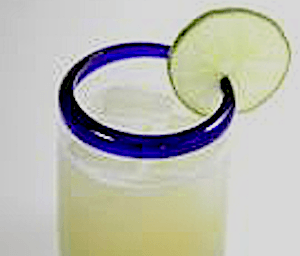 Vanilla Margarita - a cocktail you're going to crave 17 Closeup of Vanilla Margarita in glass with blue rim and lime wedge