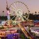 Sunset image of a romantic date at the LA County Fair ferris wheel and other ride attractions