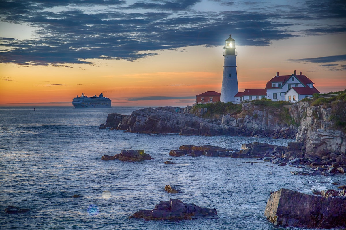 Two Lights Lighthouse, Cape Elizabeth at sunset with a cruise ship in the background