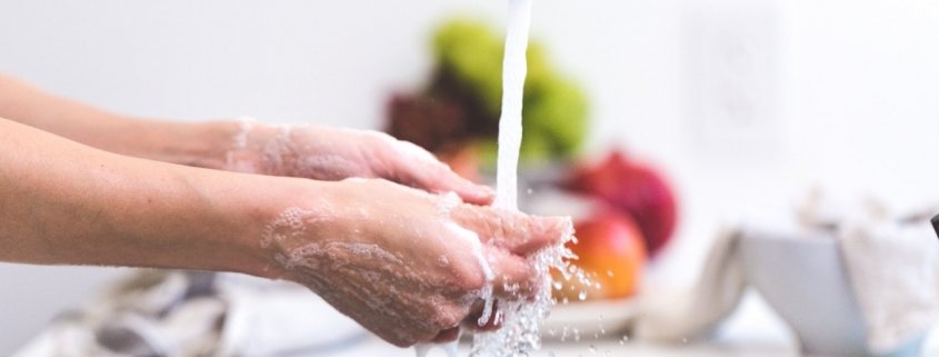 scrubbing hands at the kitchen sink