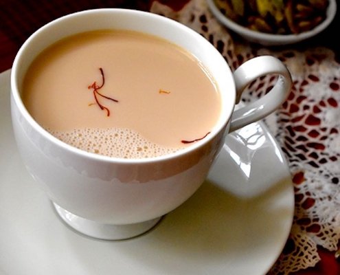 closeup of saffron chia in a white cup with a white saucer