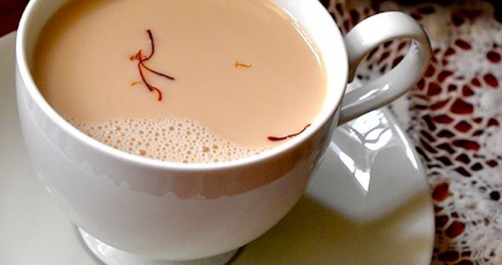 closeup of saffron chia in a white cup with a white saucer