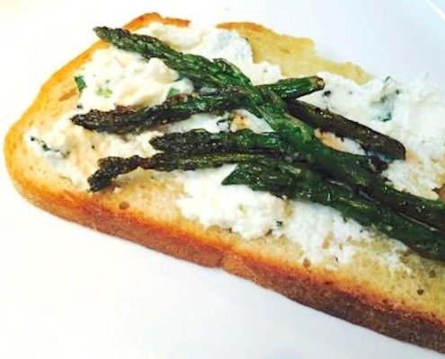 Kale Guacamole (aka Kale-A-Mole) 1 Asparagus & Ricotta Toast with Avocado Oil on a white plate