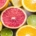 a variety of cut citrus fruits in shades of pink, orange, yellow and green