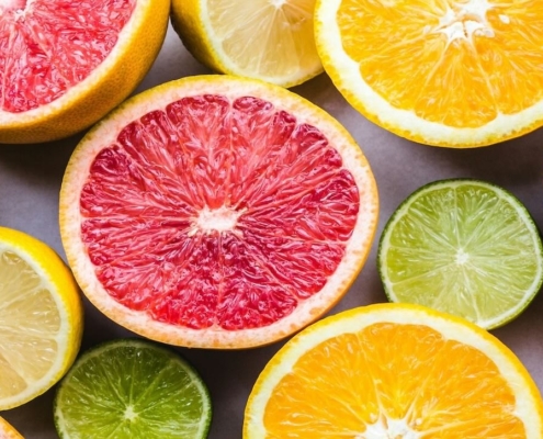 a variety of cut citrus fruits in shades of pink, orange, yellow and green