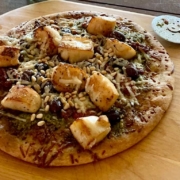 homemade scallop pizza on a wooden board