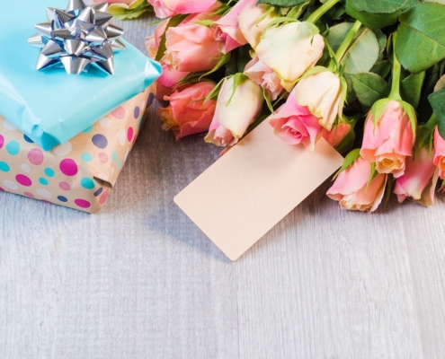 Sexy Mother's Day Gifts that Actually Work 22 A collage of wrapped presents and flowers to help illustrate sexy mother's day gifts