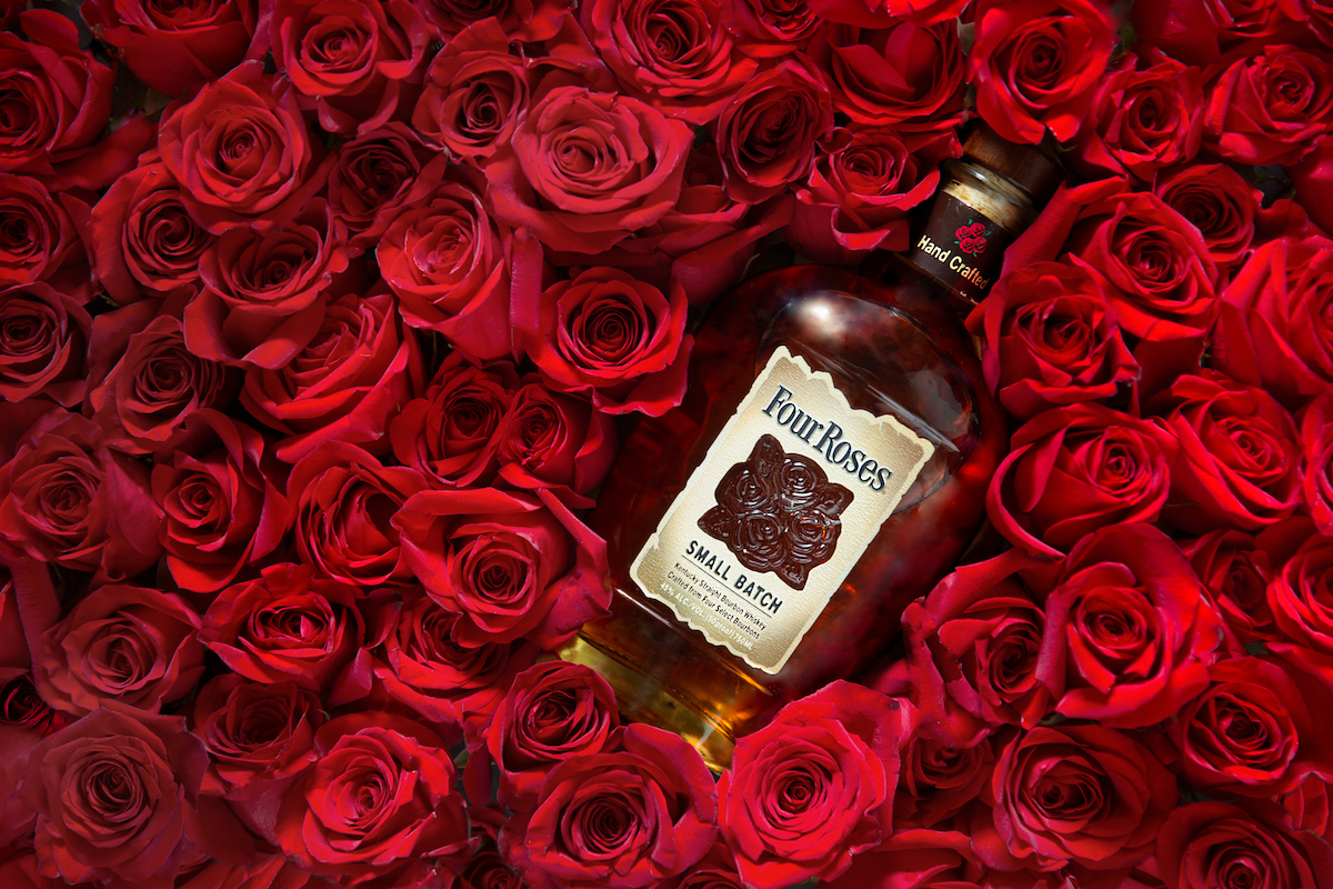 four roses bourbon in a bed of red roses