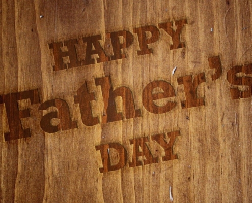 Happy Father's Day written on a brown board