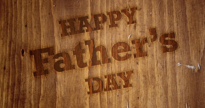 Happy Father's Day written on a brown board
