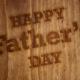 Happy Father's Day written on a brown board