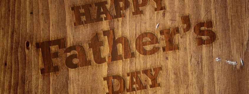 Happy Father's Day written on a brown board