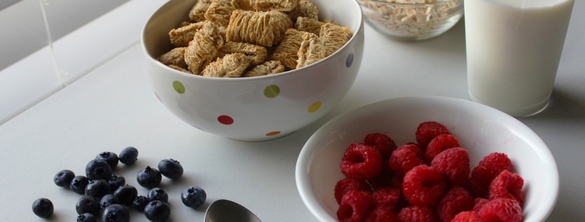 breakfast tray with berries and whole grains, glass of milk