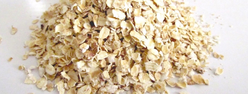 A bowl of oatmeal with sliced bananas and chopped nuts