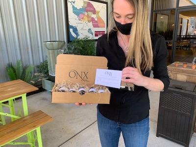 Woman holding an ONX wine tasting kit