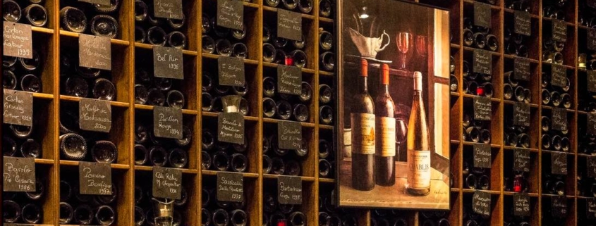 well organized, dimly lit, home wine cellar