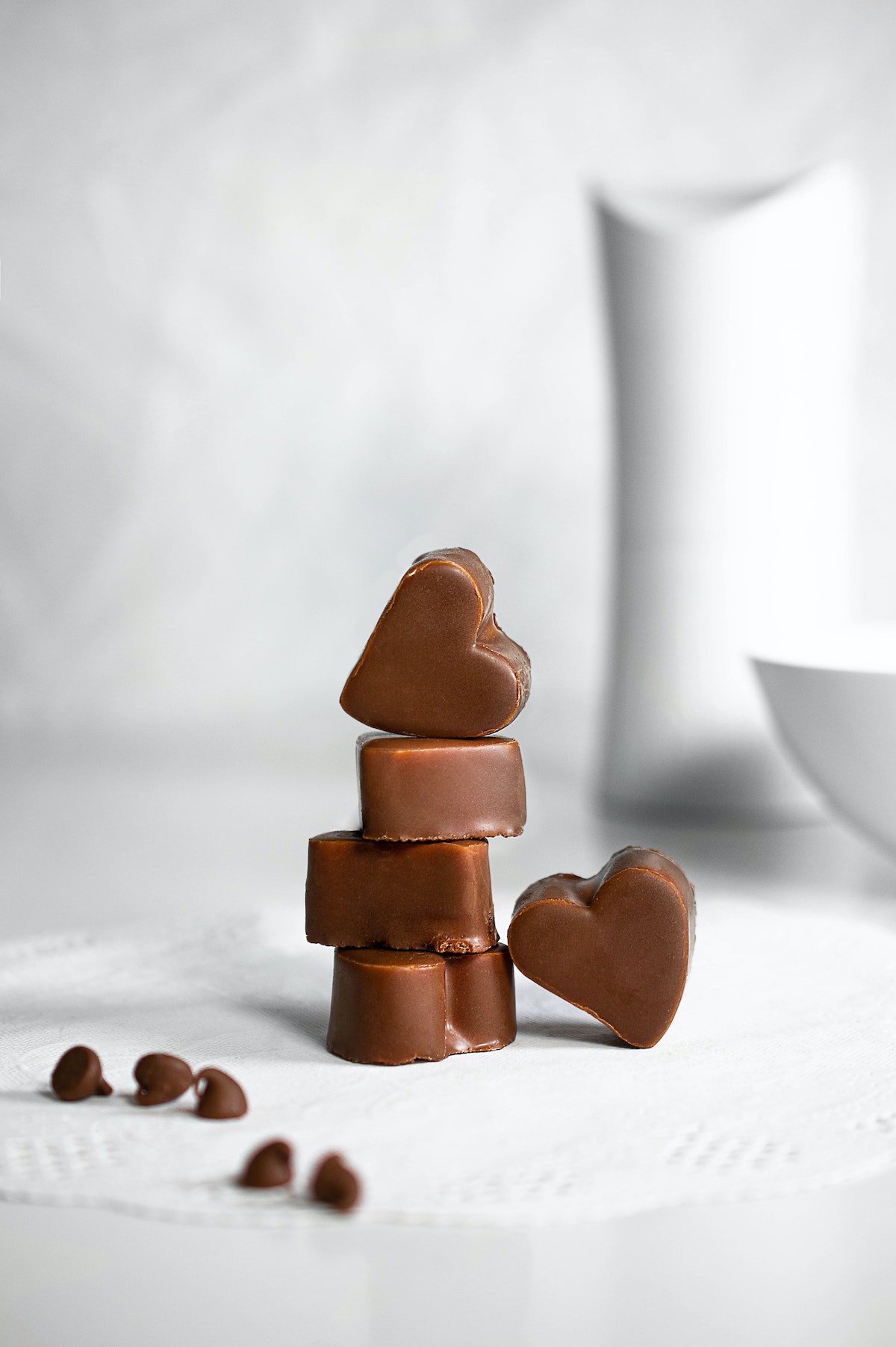 A stack of heart shaped chocolates on a white background