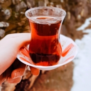 woman's hand holding a sorrel drink in the snow