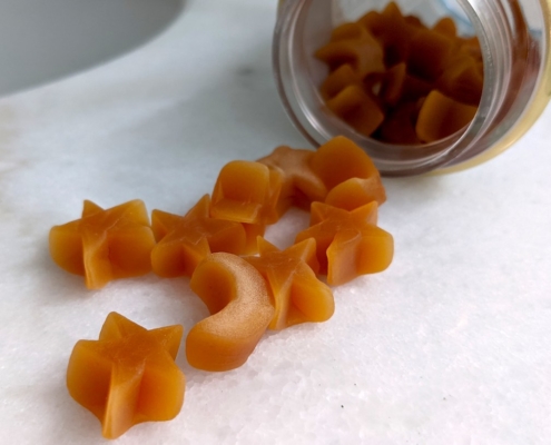 Do Sleep Gummies Work? 6 Nature's Bounty Sleep gummies spilling from thee bottle on a marble counter
