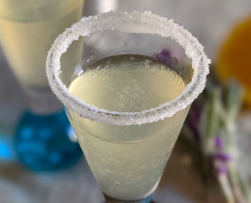 closeup of a lavender lemon drop shooter with a sugar rim