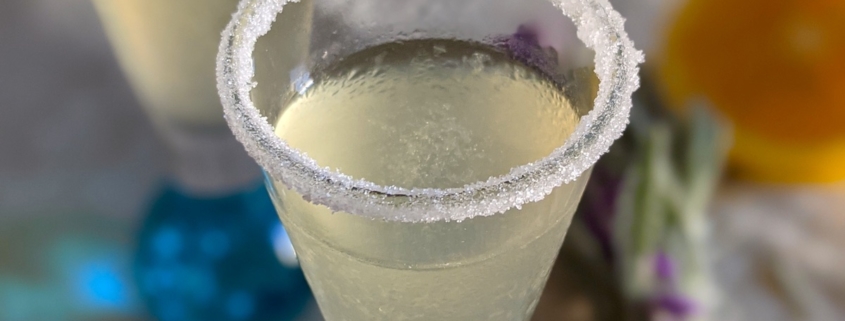 closeup of a lavender lemon drop shooter with a sugar rim