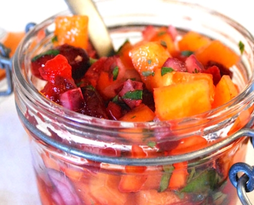 Closeup of cranberry persimmon salsa in a mason jar