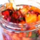 Closeup of cranberry persimmon salsa in a mason jar