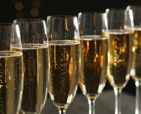 A line of saffron fleurtation cocktails in Champagne flutes