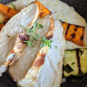 Date Night Chicken Recipe with Polenta and Vegetables 2 closeup of date night chicken with polenta and grilled vegetables in a black, stoneware bowl