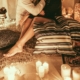 the legs of a couple in an embrace in a bedroom lit by numerous candles