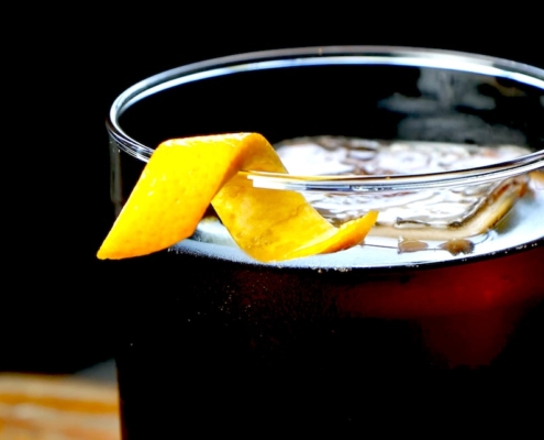 closeup of an espresso old fashioned with a twist of orange