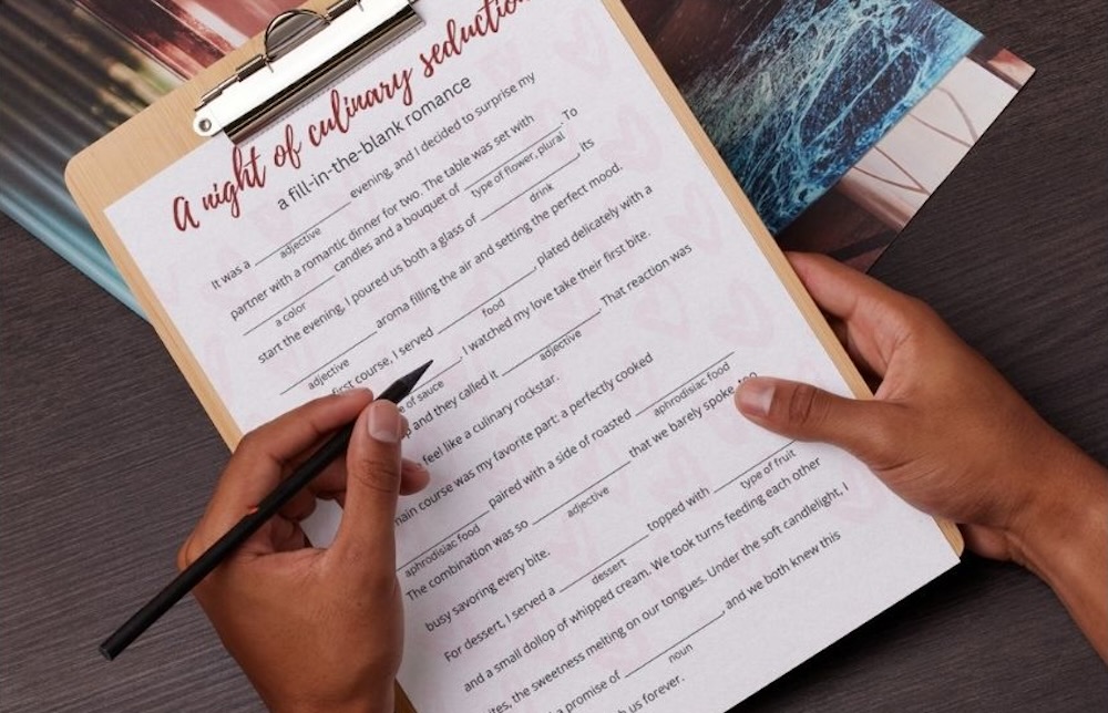 closeup of two hands filling in the blanks on a create-your-own romantic story page