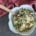 closeup of a rotisserie chicken rice bowl with a pair of chopsticks and a red and white cloth napkin