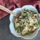 My Favorite Rotisserie Chicken Rice Bowl with Homemade Peanut Sauce 4 closeup of a rotisserie chicken rice bowl with a pair of chopsticks and a red and white cloth napkin