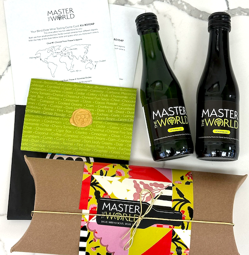 The Wine Course that Makes the Perfect Date Night In 4 Closeup of the Blind Wine Kit from Master the World wine courses with two bottles of wine, a sealed green envelope, a pillow pack tied with string and tasting sheet