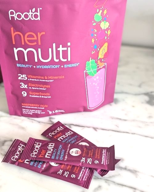 Root'd Her Multi -- the best powder multivitamin we've found 2 a package of root'd her multi with three individual serving sleeves in front of it on a white marble counter
