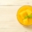 Mango nice cream in a glass dish with chunks of ripe mango and a mint sprig garnish