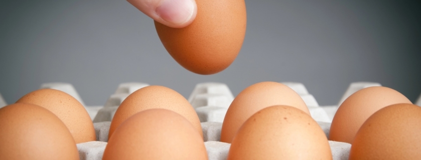 Are Eggs an Aphrodisiac? The Surprising Sexual Benefits of Eggs 1 closeup of a hand reaching to take an egg from a carton of brown eggs